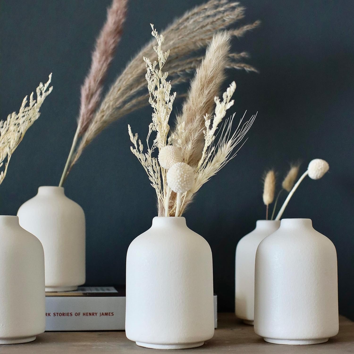 Six-piece tiny solid white ceramic bud jar bundle, casual style holders for dried plants and greenery, versatile adornment for events, indoor spaces and mixed soft countryside layouts