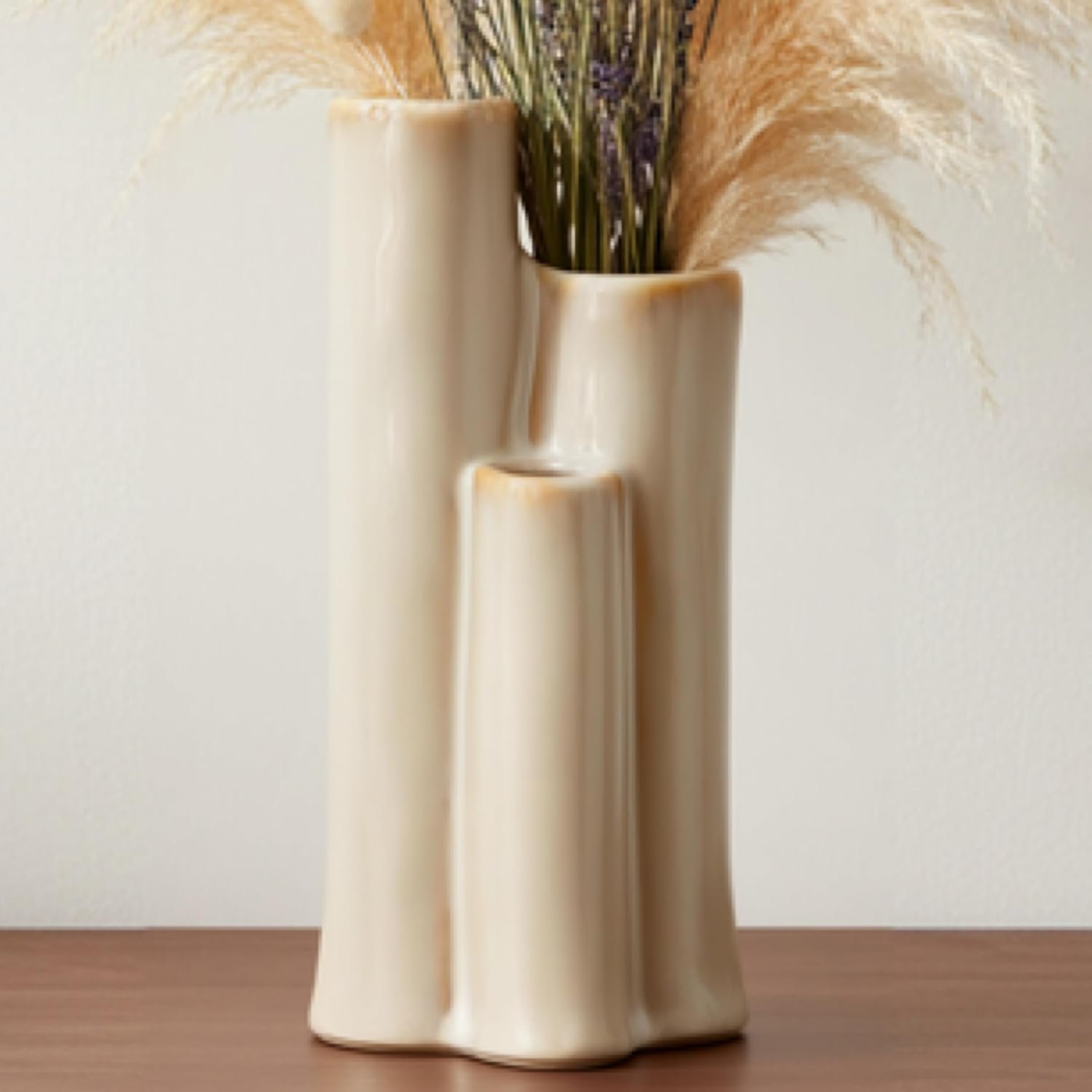 Artistically shaped ivory ceramic display jar with three openings, smooth organic minimalist styling, ideal for shelf and coffee table arrangement layouts